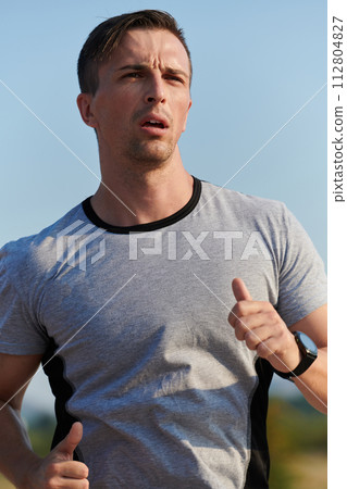 A dedicated marathon runner pushes himself to the limit in training. 112804827