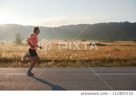 Determined Dawn: Confident and Motivated Athlete Embarks on Sunrise Run. Determined Dawn: Confident and Motivated Athlete Embarks on Sunrise Run. 112805310