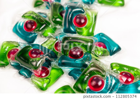 Lots of laundry pods on satin fabric close-up. 112805374