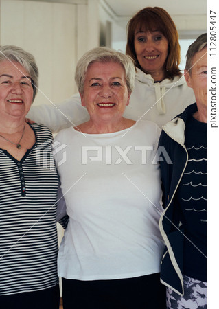 A vibrant community of senior women, guided by their instructor, embraces the enriching journey of yoga, fostering unity, well-being, and a shared commitment to active aging 112805447