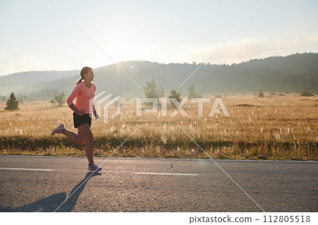 Determined Dawn: Confident and Motivated Athlete Embarks on Sunrise Run. Determined Dawn: Confident and Motivated Athlete Embarks on Sunrise Run. 112805518