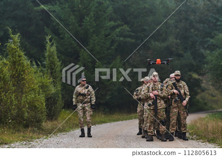 An elite military unit, led by a major, confidently parades through dense forest, showcasing precision, discipline, and readiness for high-risk operations 112805613