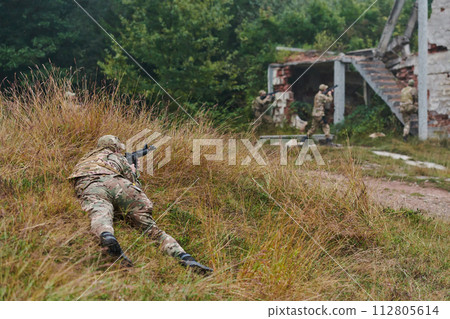 In a high stakes mission, a specialized military unit executes a tactical operation to secure a dangerous house where terrorists are believed to be hiding, showcasing precision and coordinated 112805614