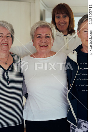 A vibrant community of senior women, guided by their instructor, embraces the enriching journey of yoga, fostering unity, well-being, and a shared commitment to active aging 112805711