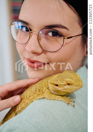 Beautiful Woman Posing with Her Adorable Bearded Dragon Pets Beautiful Woman Posing with Her Adorable Bearded Dragon Pets 112805725