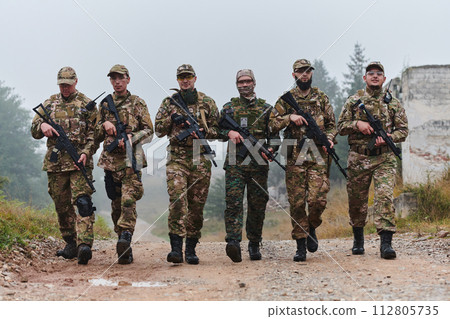 A disciplined and specialized military unit, donned in camouflage, strategically patrolling and maintaining control in a high-stakes environment, showcasing their precision, unity, and readiness for A disciplined and specialized military unit, donned in camouflage, strategically patrolling and maintaining control in a high-stakes environment, showcasing their precision, unity, and readiness for 112805735