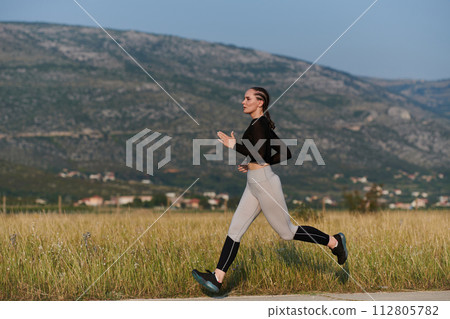 Solo Stride: Determined Athlete Woman Embarks on Fitness Journey for Marathon Preparation. 112805782