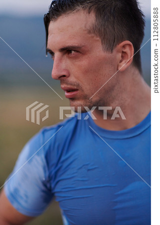 Post-Run Repose: Sweaty Athlete Rests After Intense Daily Run. 112805888