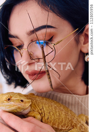 Woamn and Her Pets: A Bearded Dragon and a Stick Insect 112805956