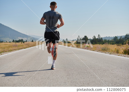 A dedicated marathon runner pushes himself to the limit in training. 112806075