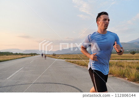 A dedicated marathon runner pushes himself to the limit in training. 112806144