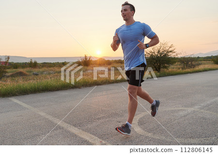 A dedicated marathon runner pushes himself to the limit in training. 112806145