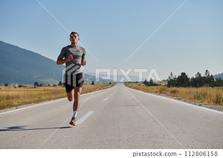 A dedicated marathon runner pushes himself to the limit in training. 112806158
