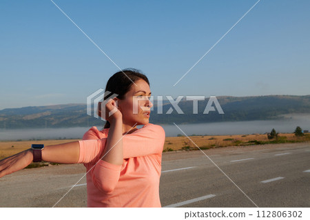 Determined Stretch: Athletic Woman Embraces Post-Run Flexibility in Nature. Determined Stretch: Athletic Woman Embraces Post-Run Flexibility in Nature. 112806302