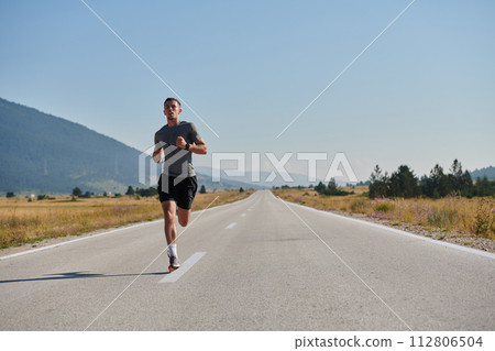 A dedicated marathon runner pushes himself to the limit in training. 112806504