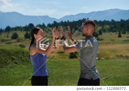 Victorious Embrace: Romantic Couple Handshakes After Successful Daily Run. 112806572