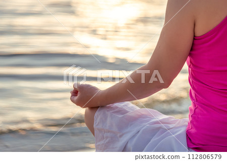 Woman meditating at the sea 112806579