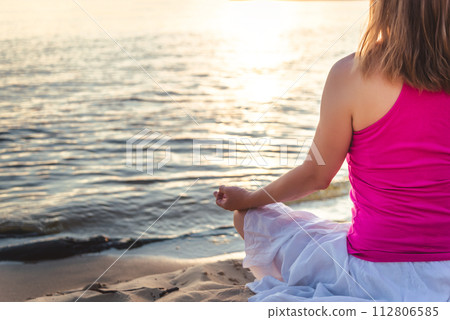 Woman meditating at the sea Woman meditating at the sea 112806585