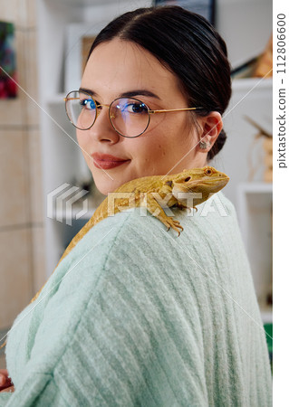 Beautiful Woman Posing with Her Adorable Bearded Dragon Pets Beautiful Woman Posing with Her Adorable Bearded Dragon Pets 112806600
