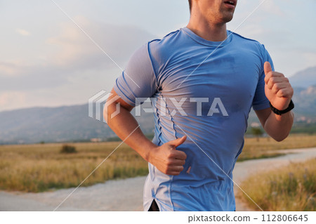 A dedicated marathon runner pushes himself to the limit in training. 112806645