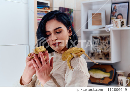 Beautiful Woman Posing with Her Two Adorable Bearded Dragon Pets 112806649