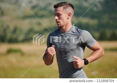 A dedicated marathon runner pushes himself to the limit in training. 112806704