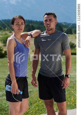 After-Run Relaxation: Romantic Couple Rests Following Intense Training Session. 112806966
