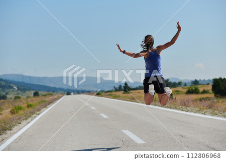 Leap of Victory: Athlete Symbolizes Success and Dedication Through Mid-Air Jump. 112806968