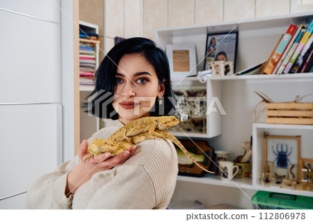 Beautiful Woman Posing with Her Two Adorable Bearded Dragon Pets 112806978