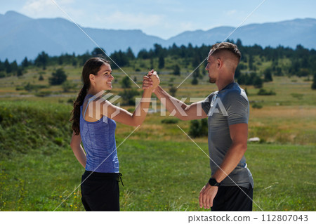 Victorious Embrace: Romantic Couple Handshakes After Successful Daily Run. Victorious Embrace: Romantic Couple Handshakes After Successful Daily Run. 112807043