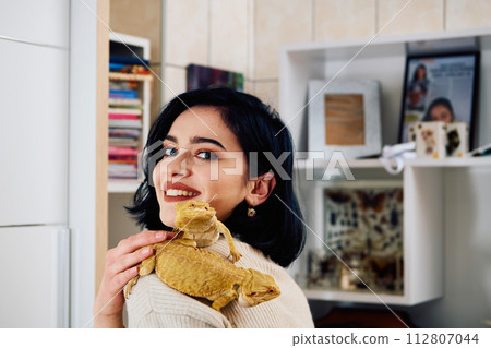 Beautiful Woman Posing with Her Two Adorable Bearded Dragon Pets 112807044