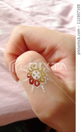 Metallic tattoo on thumb Metallic tattoo on thumb 112807108