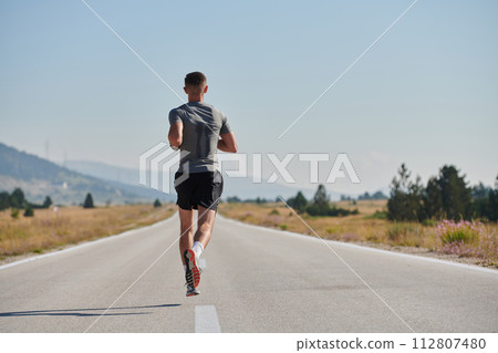 A dedicated marathon runner pushes himself to the limit in training. 112807480