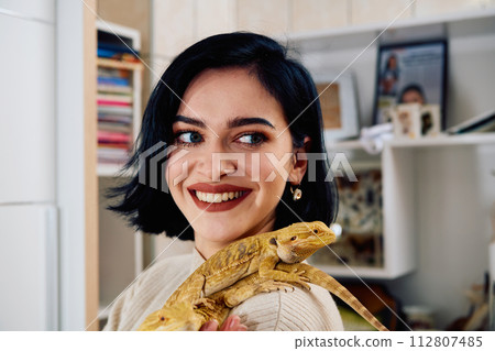 Beautiful Woman Posing with Her Two Adorable Bearded Dragon Pets Beautiful Woman Posing with Her Two Adorable Bearded Dragon Pets 112807485