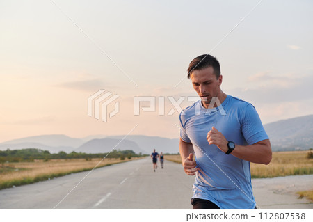 A dedicated marathon runner pushes himself to the limit in training. 112807538