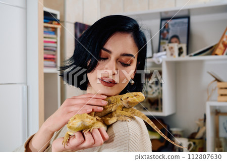 Beautiful Woman Posing with Her Two Adorable Bearded Dragon Pets 112807630