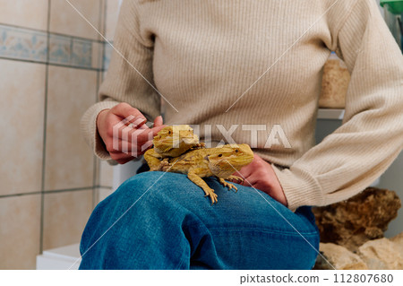 Beautiful Woman Posing with Her Two Adorable Bearded Dragon Pets Beautiful Woman Posing with Her Two Adorable Bearded Dragon Pets 112807680