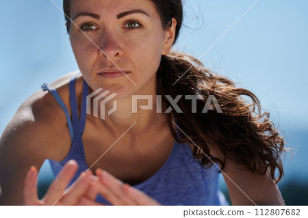 Determined Stretch: Athletic Woman Embraces Post-Run Flexibility in Nature. Determined Stretch: Athletic Woman Embraces Post-Run Flexibility in Nature. 112807682