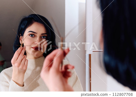 Young Woman Captured in a Beautiful Moment with Her Stick Insect (Medauroidea Extradentata) Young Woman Captured in a Beautiful Moment with Her Stick Insect (Medauroidea Extradentata) 112807708