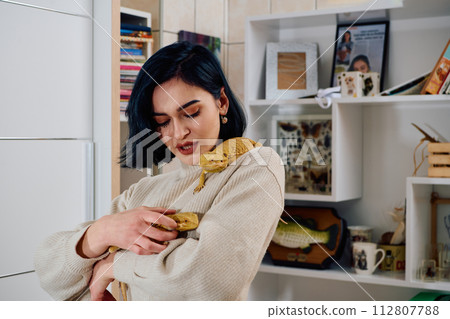 Beautiful Woman Posing with Her Two Adorable Bearded Dragon Pets Beautiful Woman Posing with Her Two Adorable Bearded Dragon Pets 112807788