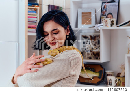 Beautiful Woman Posing with Her Two Adorable Bearded Dragon Pets Beautiful Woman Posing with Her Two Adorable Bearded Dragon Pets 112807810