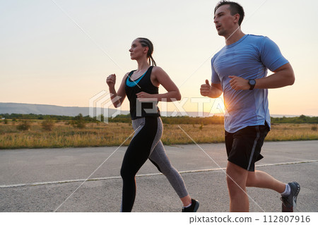 Dynamic Duo: Fitness-Ready Couple Embraces Confidence and Preparation for Upcoming Marathons 112807916