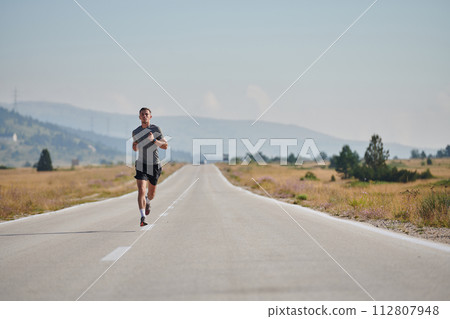 A dedicated marathon runner pushes himself to the limit in training. 112807948