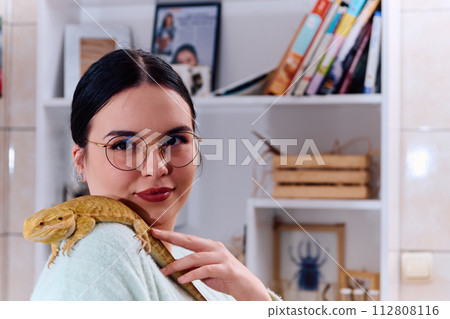 Beautiful Woman Posing with Her Adorable Bearded Dragon Pets Beautiful Woman Posing with Her Adorable Bearded Dragon Pets 112808116