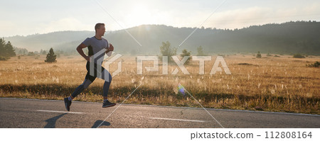 Determined Stride: Athletic Man Embarks on Marathon Preparation with Resolve. Determined Stride: Athletic Man Embarks on Marathon Preparation with Resolve. 112808164