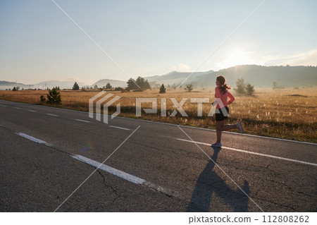Determined Dawn: Confident and Motivated Athlete Embarks on Sunrise Run. Determined Dawn: Confident and Motivated Athlete Embarks on Sunrise Run. 112808262
