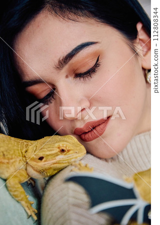 Beautiful Woman Posing with Her Adorable Bearded Dragon Pets Beautiful Woman Posing with Her Adorable Bearded Dragon Pets 112808344