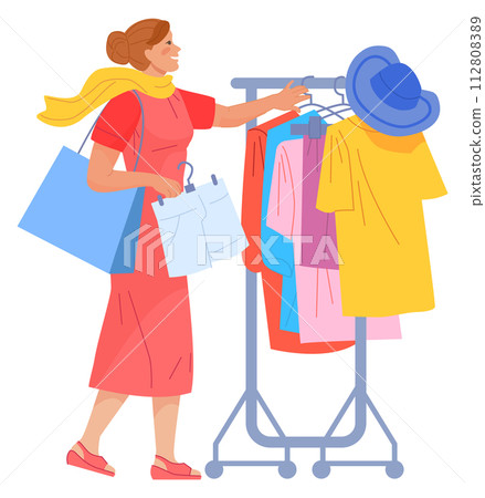 Woman in clothes store choose dress from hanging racks Woman in clothes store choose dress from hanging racks 112808389
