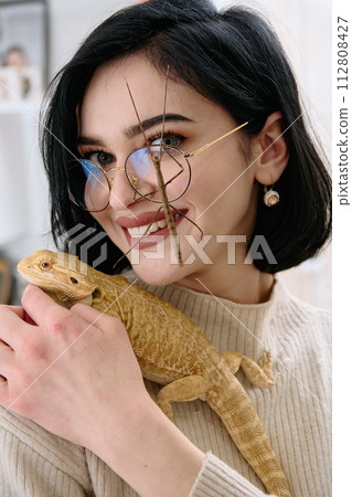 Woamn and Her Pets: A Bearded Dragon and a Stick Insect 112808427