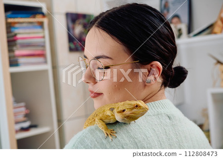 Beautiful Woman Posing with Her Adorable Bearded Dragon Pets Beautiful Woman Posing with Her Adorable Bearded Dragon Pets 112808473